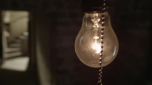 Lightbulb in a dark corner of a basement
