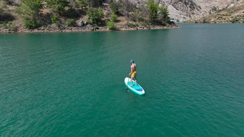 Aerial View Paddleboarding Adventure in the Green Canyon People Relax and Enjoy Summer