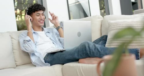 Young Adult Using Laptop on Cream Couch
