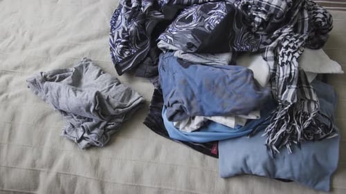 Throwing clothes in the bed