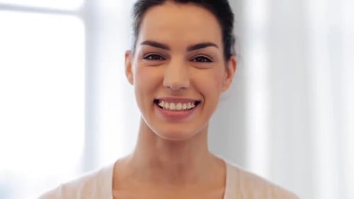 Smiling Young Brunette Woman Looking at Camera