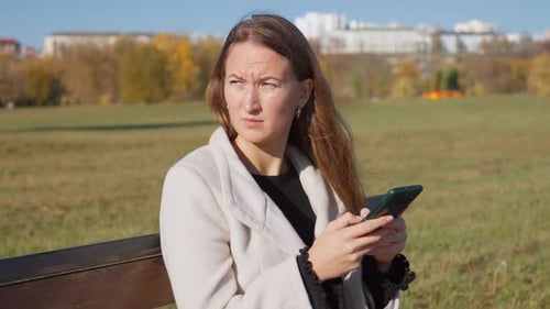 Female tourist in straw shyap at resort choosing and buying clothes at market
