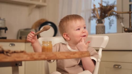 Adorable Child Eats in a Sunny Kitchen