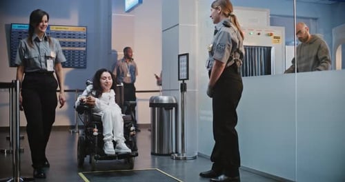 Security Checkpoint in Airport Terminal Female Security Officer Inspecting Woman in Wheelchair