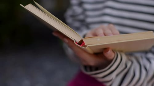 Woman Reading Open Book Turning Page