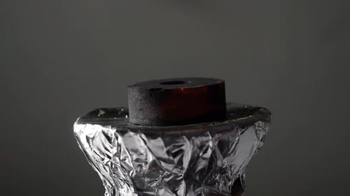 Hookah Charcoal Burning on Foil Close-Up