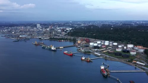 Rising view of Docked Oil Tanker Ships and Pertamina Oil Refinery in the background - Port of Balikp