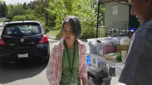 Volunteers with Board Filling Out Paperwork in Parking Lot