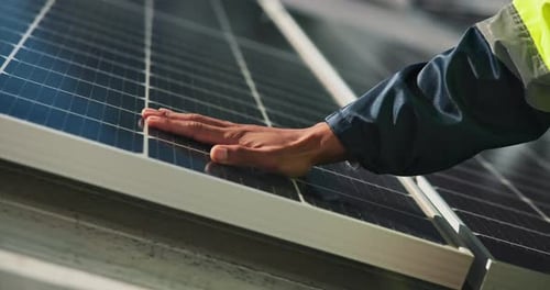 Engineering Worker Inspecting Solar Panel Installation