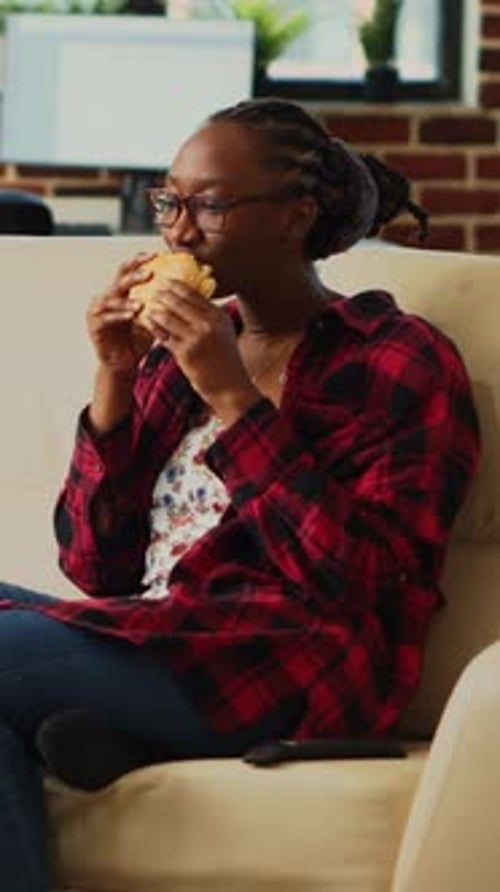 Vertical Video Smiling Adult Eating Hamburger with Fries and Alcohol
