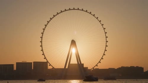 Sun shining behind the Ain Dubai, Dubai, UAE