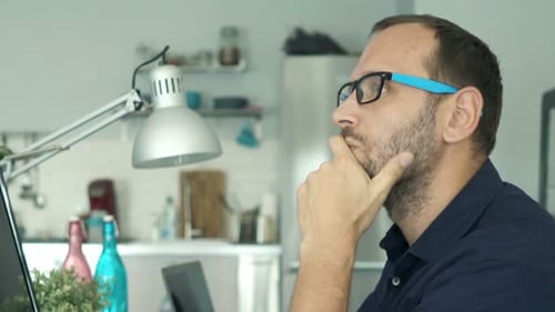 Young Man with Pc Computer Thinking, Truing to Solve Problem at Home Adult