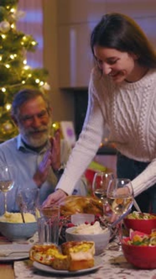Family Christmas Dinner: Young Woman Serves Roasted Chicken