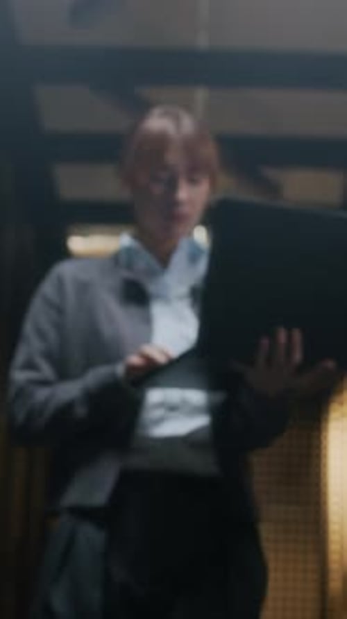 Vertical of Young Professional Female IT Specialist Working in Data Center