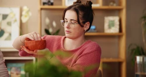 Young Woman Shaping Clay into a Bowl Indoors