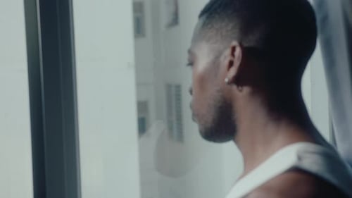 Black Guy Looking Through the Window at Home