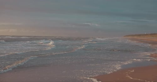 Waves Softly Crashing Against the Shore at Sunset Along the Coast of Hirtshals, Denmark, Europe - Wi