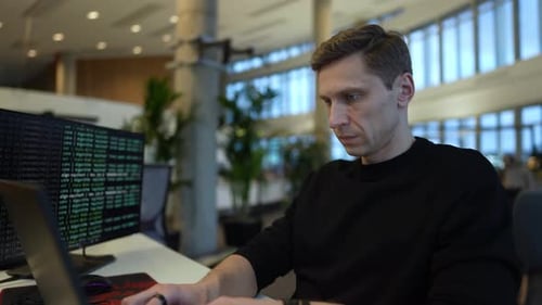 a programmer works at a computer, programs a neural network