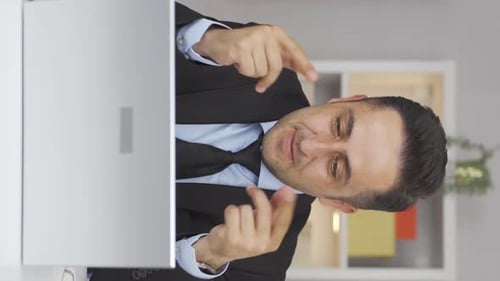 Vertical video of Home office worker man attending online business meeting.