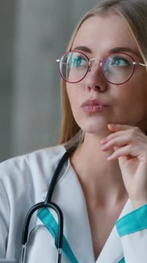 Woman Doctor Thinking with Hand to Face Close-up