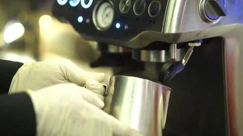 Close-Up View Of Coffee Machine Holder Filling Up Metal Cup With Hot Milk. Slow Motion