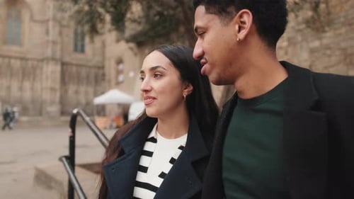Young Couple Walking and Talking in City