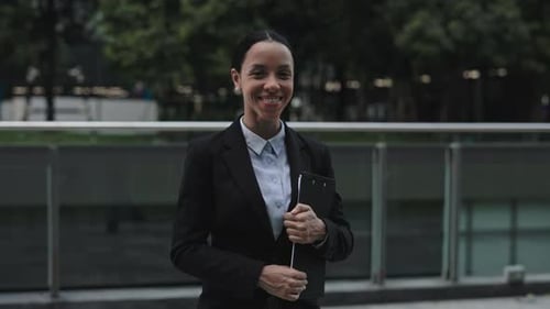 Confident Young Woman Smiling in Business Attire