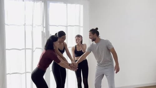 Happy group of diverse friends doing yoga in studio, meditating