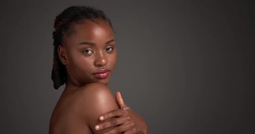 Shoulder, beauty and face of black woman in studio for skincare, body care and clear skin glow