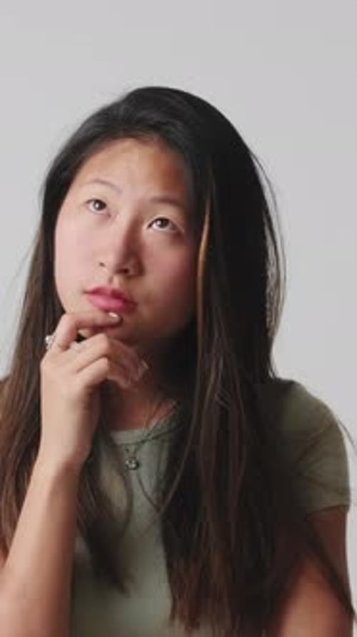 Young woman doubt and thinking with confusion isolated over white background in studio