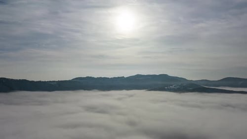 Timelapse shot over the clouds while sunrise sky. A sea of fog is formed from stratus. Foggy valley