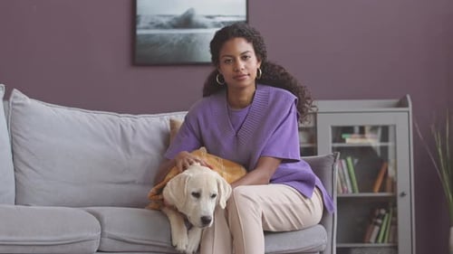 Portrait of Young Woman with Dog at Home