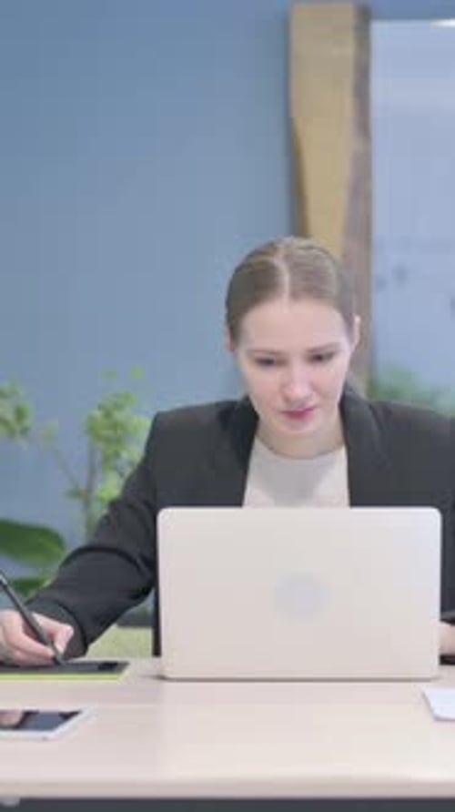 Female Graphic Designer Working on Laptop and Graphic Tablet, Vertical Video