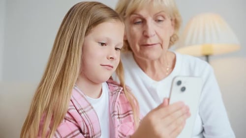 Closeup of Grandmother and Granddaughter on Video Call