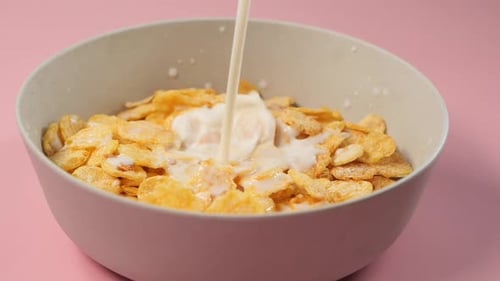 Milk Poured into Bowl of Corn Flakes