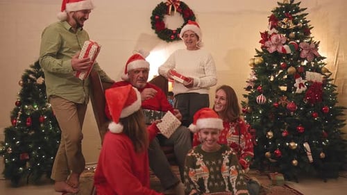 Family Celebrating Christmas Exchanging Gifts