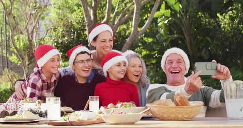 Happy caucasian family having christmas dinner in garden