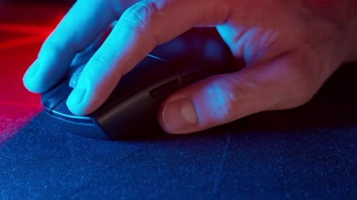 Hand Using Gaming Mouse on Mousepad Close Up