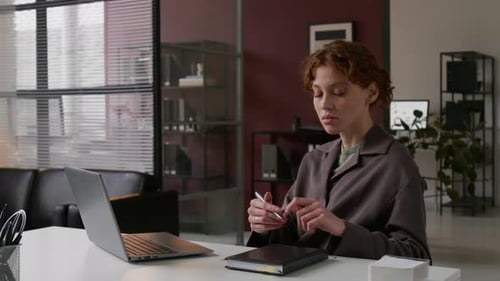 Woman Works at Laptop in Modern Office
