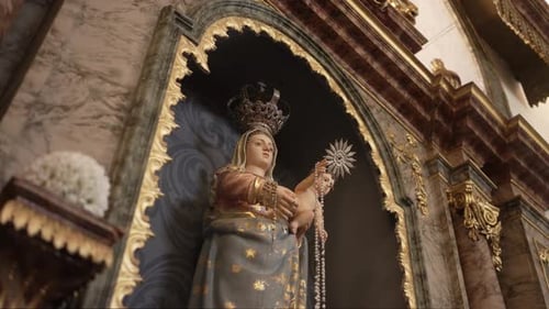 Intricate religious statue of Madonna and Child in a gilded church alcove