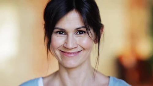 Smiling woman portrait in a brightly lit home