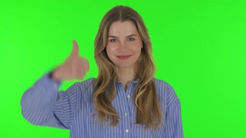Young Woman with Thumbs Up on Green Background