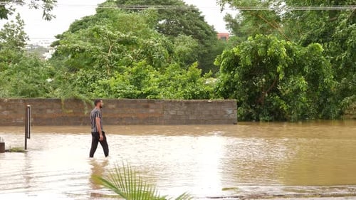 A man walks through floodwaters in Ahmedabad city