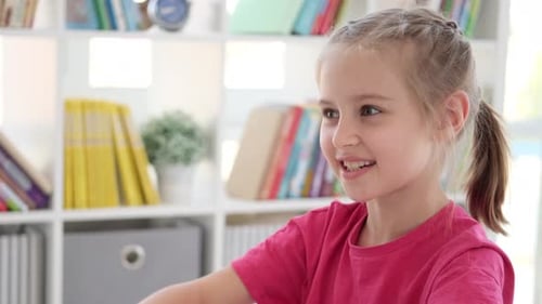 Smiling Child with Braids at Home