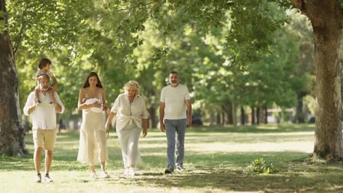 Family Members Enjoying a Leisurely Walk Together in a Beautiful Park Setting