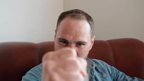 Man Making a Fist Angrily Towards the Camera