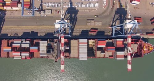 Commercial port with container ships - Top down aerial view.