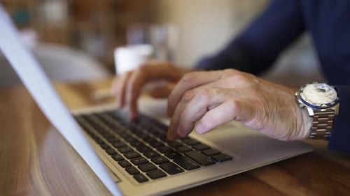 Adult Hands Typing on Laptop Computer Keyboard