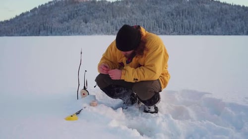Man Setting Up His Ice Fishing Trap On A Winter Day In Indre Fosen, Norway - wide