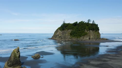 Drone Rises to Reveal Pacific Ocean Behind Large Boulder at Ruby Beach on Washington's Olympic Penin